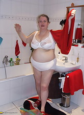 Big mama playing with whipped cream in the tub